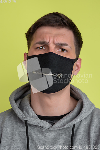 Image of Close up caucasian man\'s portrait isolated on yellow studio background - freaky model