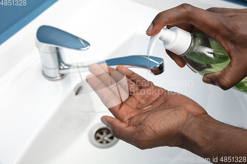 Image of Man washing hands carefully in bathroom close up. Prevention of infection and pneumonia virus spreading