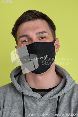 Image of Close up caucasian man\'s portrait isolated on yellow studio background - freaky model