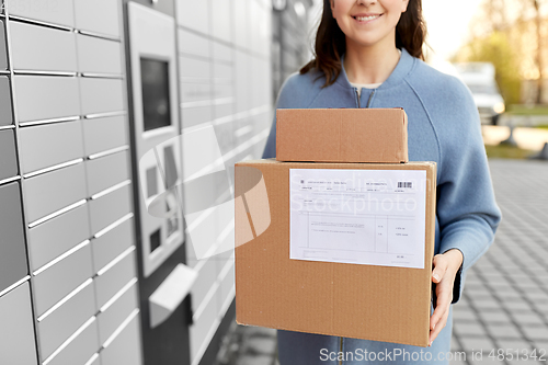 Image of woman with boxes at automated parcel machine