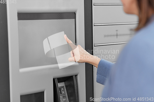 Image of woman using automated parcel machine