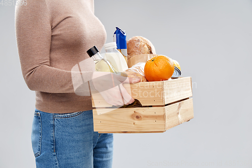 Image of close up of woman with food in wooden box