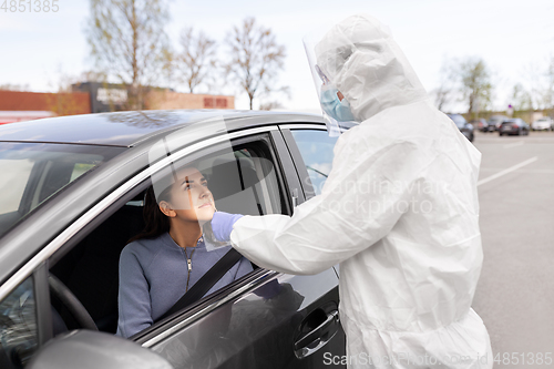 Image of healthcare worker making coronavirus test at car