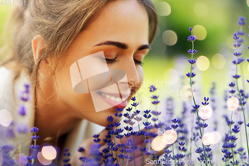 Image of close up of woman smelling lavender flowers