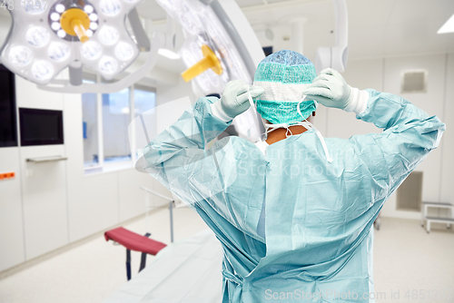 Image of male surgeon doctor in protective wear at surgery