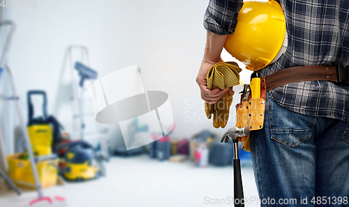 Image of worker or builder with helmet and working tools