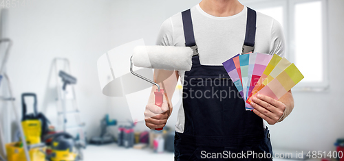 Image of close up of painter with roller and color charts