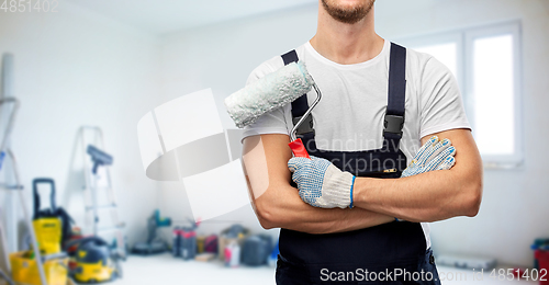 Image of close up of painter or builder with paint roller