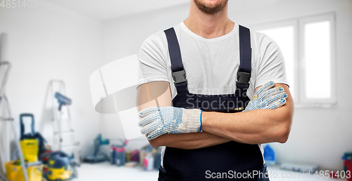 Image of close up of male builder in overall and gloves