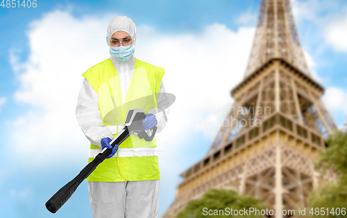 Image of sanitation worker in hazmat with pressure washer