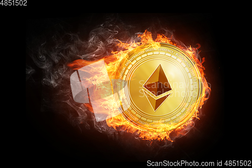 Image of Golden ethereum coin flying in fire flame.