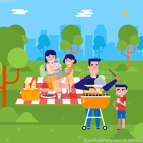 Image of Young caucasian family having a picnic in the park