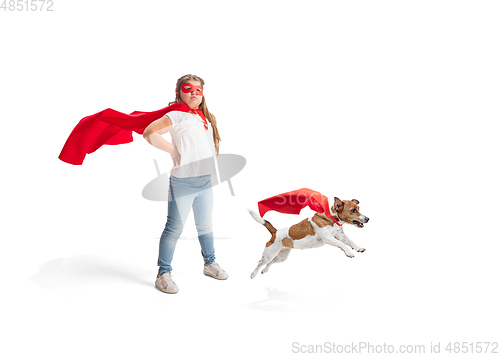 Image of Child pretending to be a superhero with her super dog isolated on white studio background