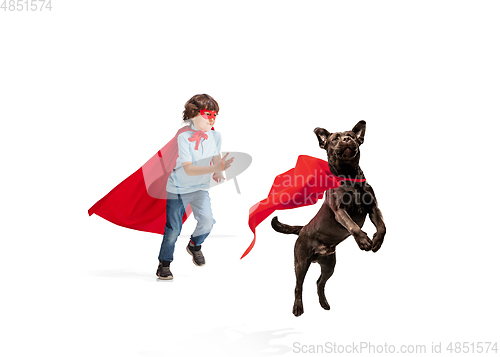 Image of Child pretending to be a superhero with his super dog isolated on white studio background