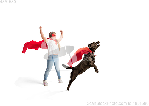 Image of Child pretending to be a superhero with her super dog isolated on white studio background