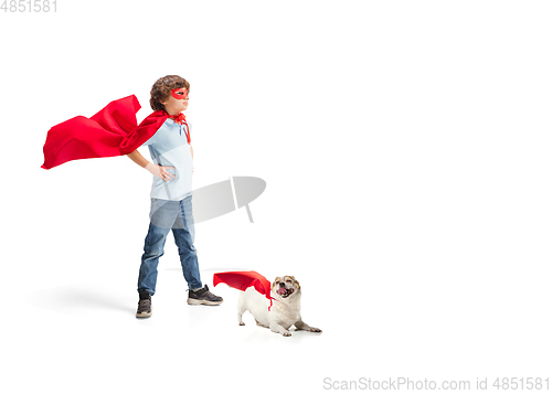 Image of Child pretending to be a superhero with his super dog isolated on white studio background