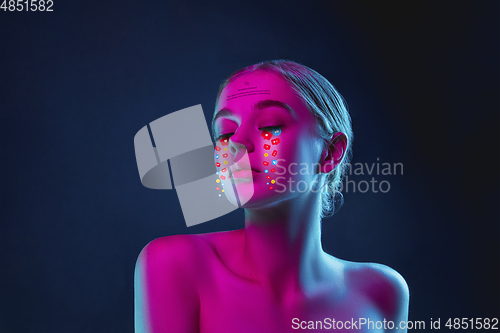 Image of Tears illustrated of social media activity signs on female face in neon light. Real life versus online lifestyle, addiction to modern technologies