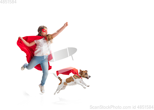 Image of Child pretending to be a superhero with her super dog isolated on white studio background