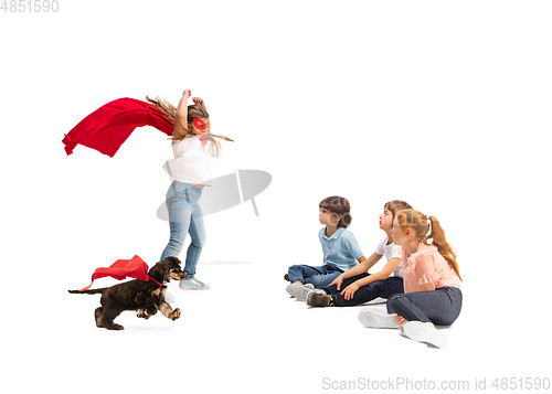Image of Child pretending to be a superhero with her super dog and friends sitting around