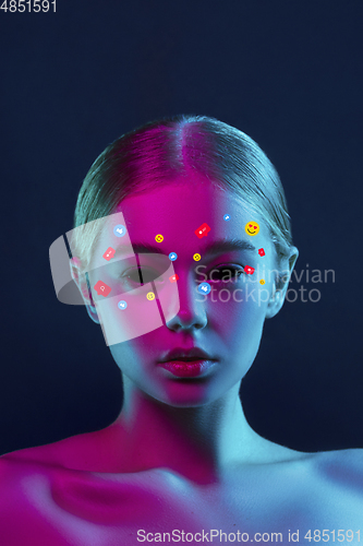 Image of Tears illustrated of social media activity signs on female face in neon light. Real life versus online lifestyle, addiction to modern technologies