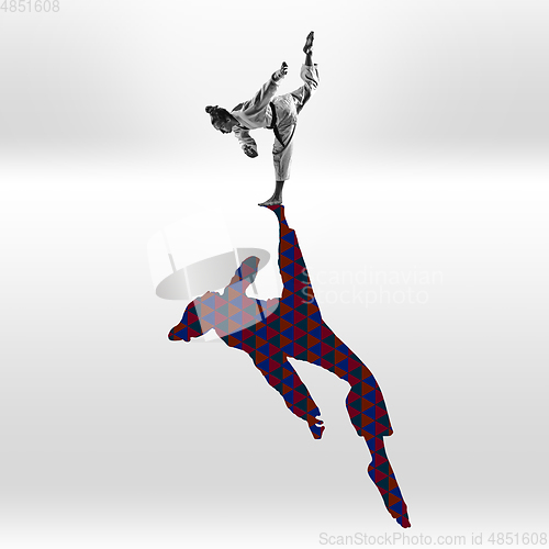 Image of Young caucasian sportswoman isolated on studio background with shadow, modern artwork. Abstract trendy design.