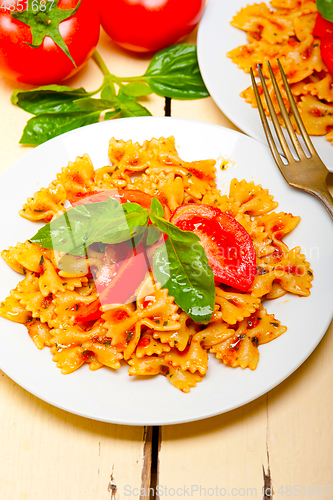 Image of Italian pasta farfalle butterfly bow-tie and tomato sauce