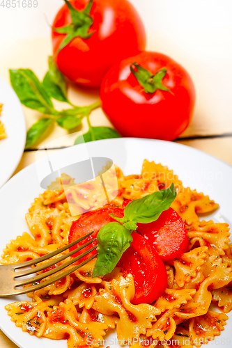 Image of Italian pasta farfalle butterfly bow-tie and tomato sauce