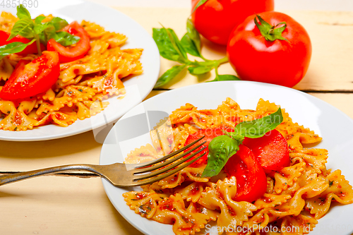 Image of Italian pasta farfalle butterfly bow-tie and tomato sauce