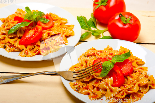 Image of Italian pasta farfalle butterfly bow-tie and tomato sauce