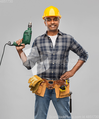 Image of happy indian builder in helmet with electric drill