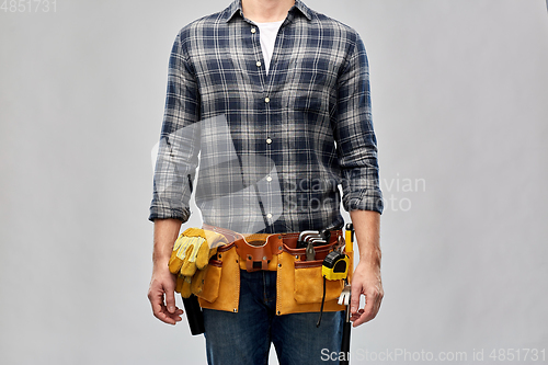 Image of male worker or builder with working tools on belt