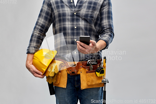 Image of worker or builder with phone and working tools