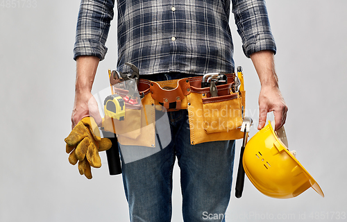 Image of worker or builder with helmet and working tools