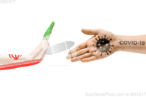 Image of Stop shaking hands. Human hands colored in flag of Iran and coronavirus - concept of spreading of virus