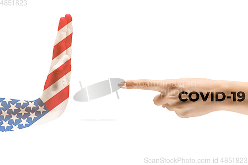 Image of Stop the epidemic. Human hands colored in flag of USA and coronavirus - concept of spreading of virus