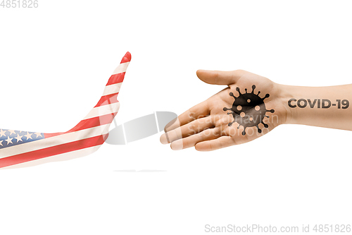 Image of Stop shaking hands. Human hands colored in flag of USA and coronavirus - concept of spreading of virus