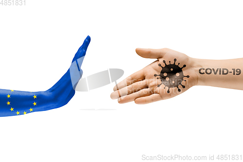 Image of Stop shaking hands. Human hands colored in flag of EU and coronavirus - concept of spreading of virus