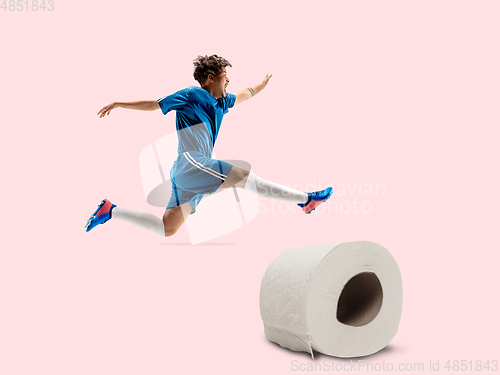 Image of Professional sportsman caught toiletpaper in motion and action - high demand for essential goods