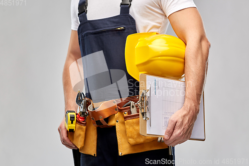 Image of male builder with clipboard and working tools