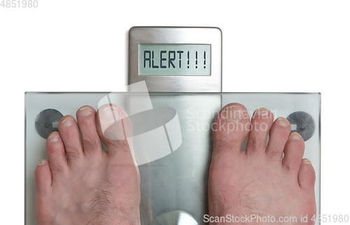 Image of Man\'s feet on weight scale - Alert