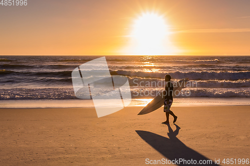 Image of Surfer walking on the beach