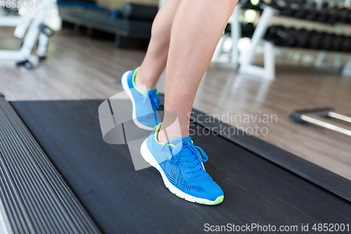 Image of Woman running on treadmill