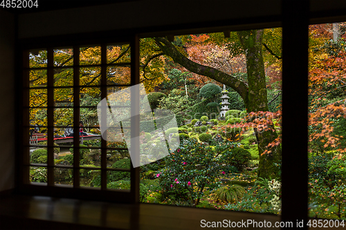 Image of Japanese wooden house with autumn landscape
