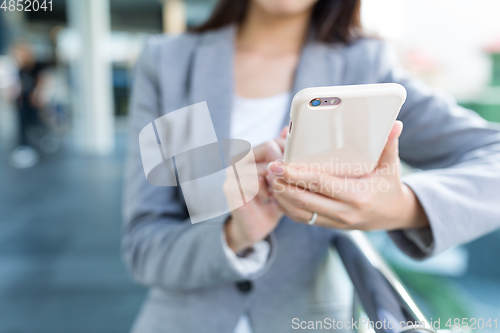 Image of Businesswoman working on cellphone
