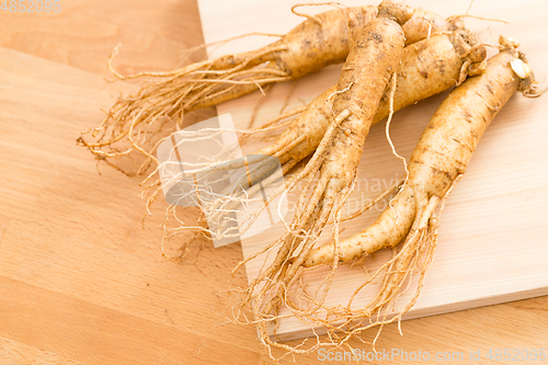 Image of Korean fresh ginseng over wooden texture