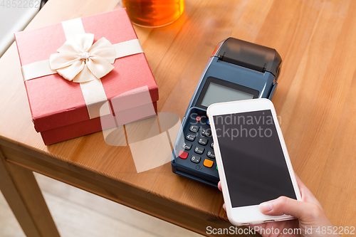 Image of Cellphone pay on pos machine with the gift
