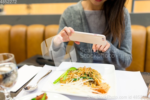 Image of woman taking photo on her dishes