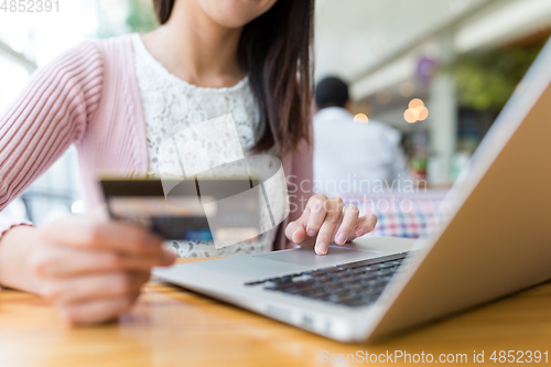 Image of Woman using credit card to pay the bill