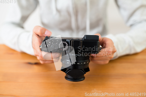 Image of Woman checking on digital camera