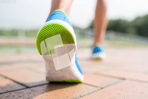 Image of Woman running at city